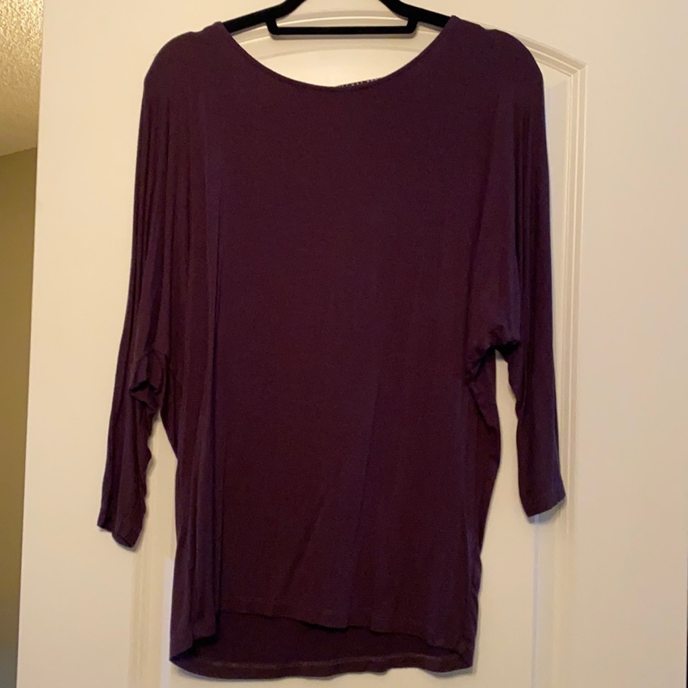 Will be donated 10/01. 
NEVER WORN. Dolman sleeve top with zebra detail on back.